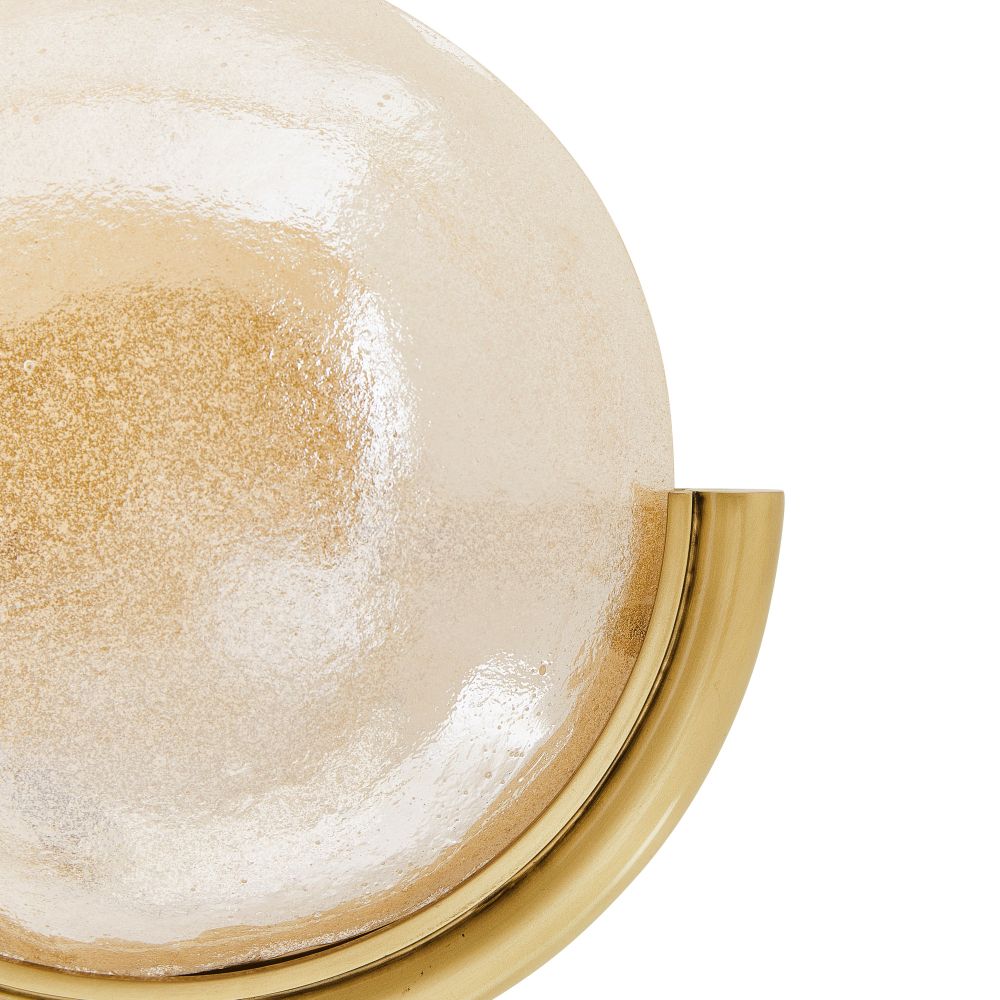 Close-up of a gold-framed mirror with a textured surface