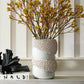 White textured vase with dried flowers on a shelf