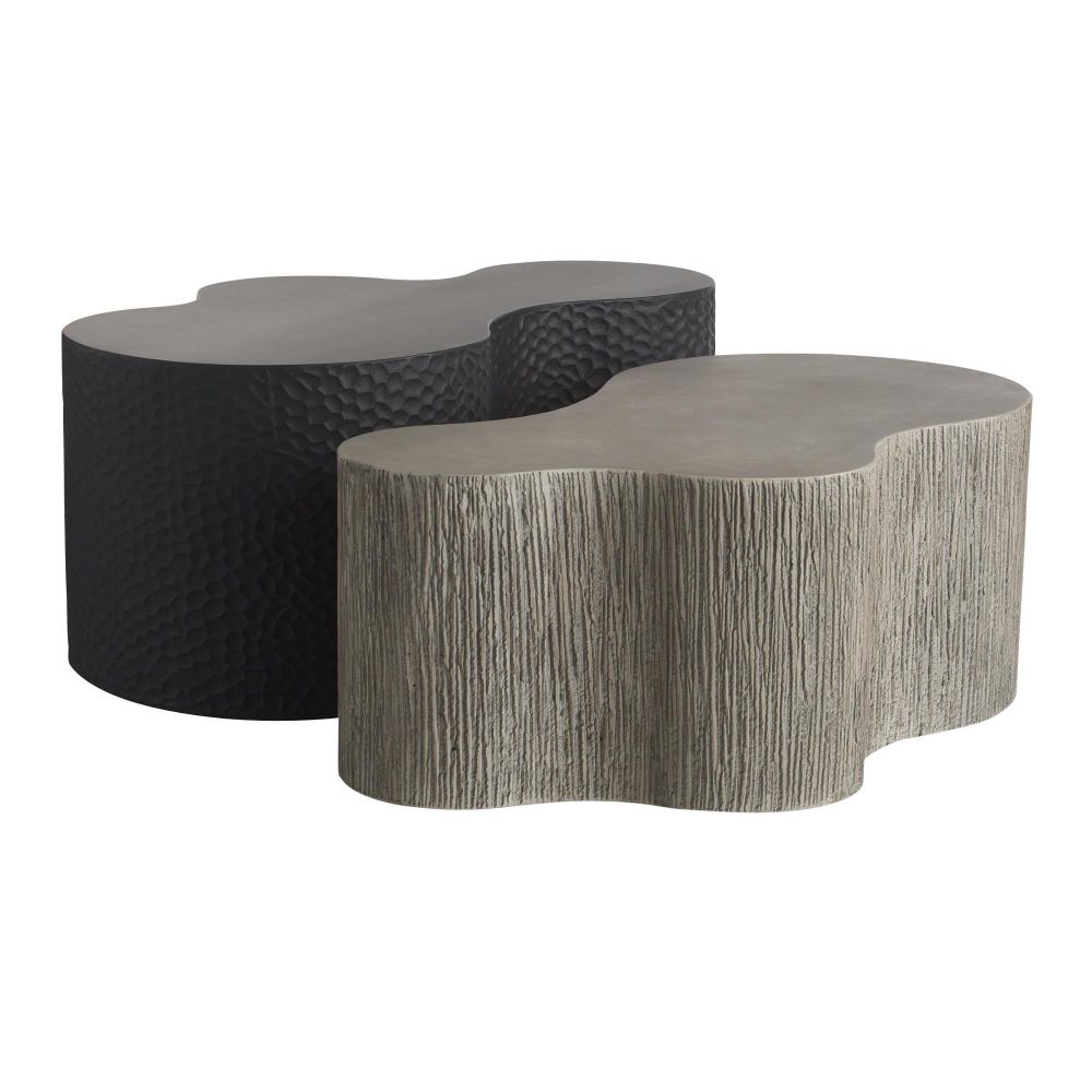 Two modern coffee tables with unique, wavy designs on a white background