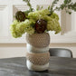 Decorative vase with green flowers on a table