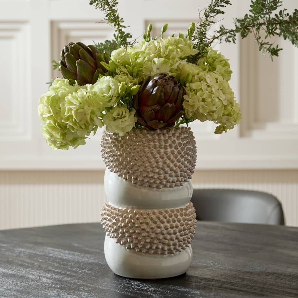 Decorative vase with green flowers on a table