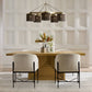 Dining room with wooden table, chairs, and decorative elements against a paneled wall.