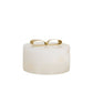White cylindrical container with a gold lid on a white background