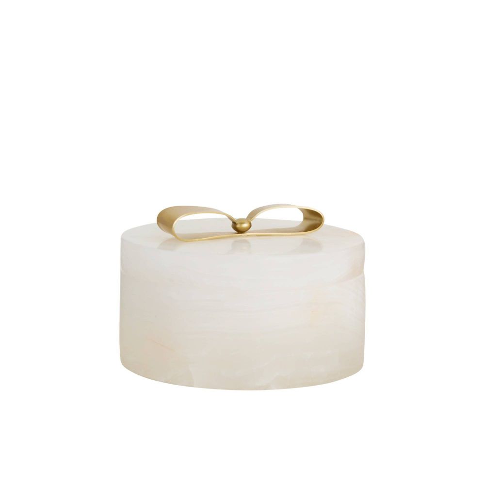 White cylindrical container with a gold lid on a white background