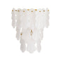 White tassel wall light fixture on a white background