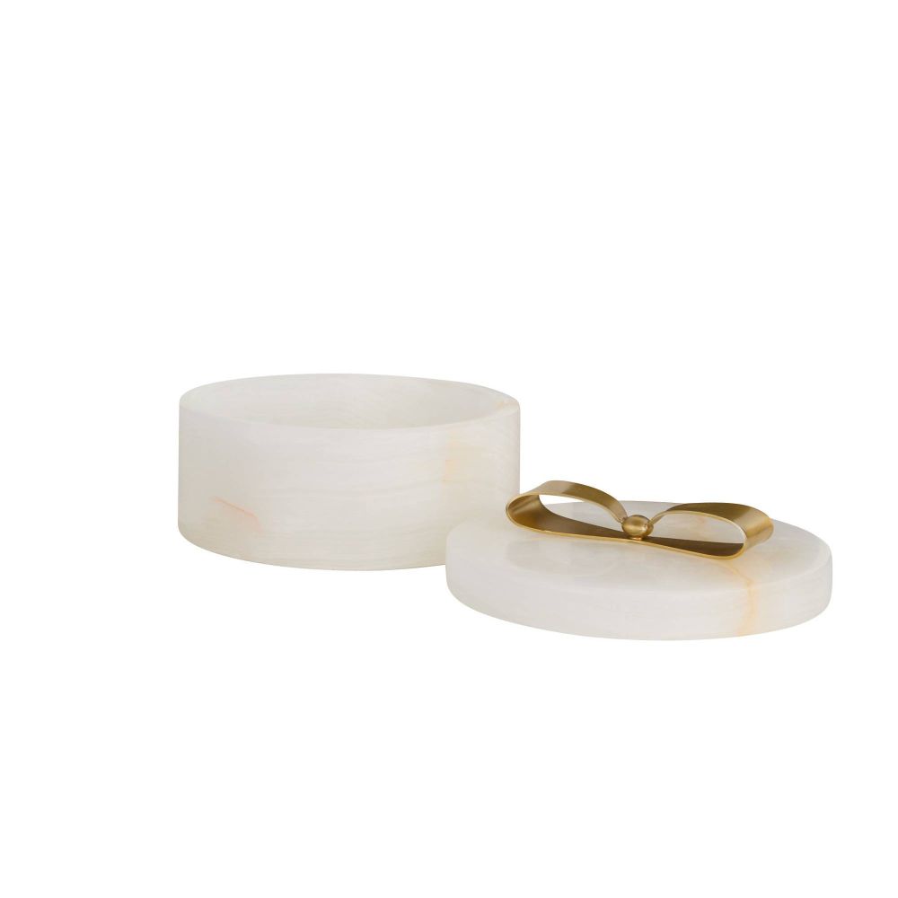 White cylindrical container with gold lid on a white background