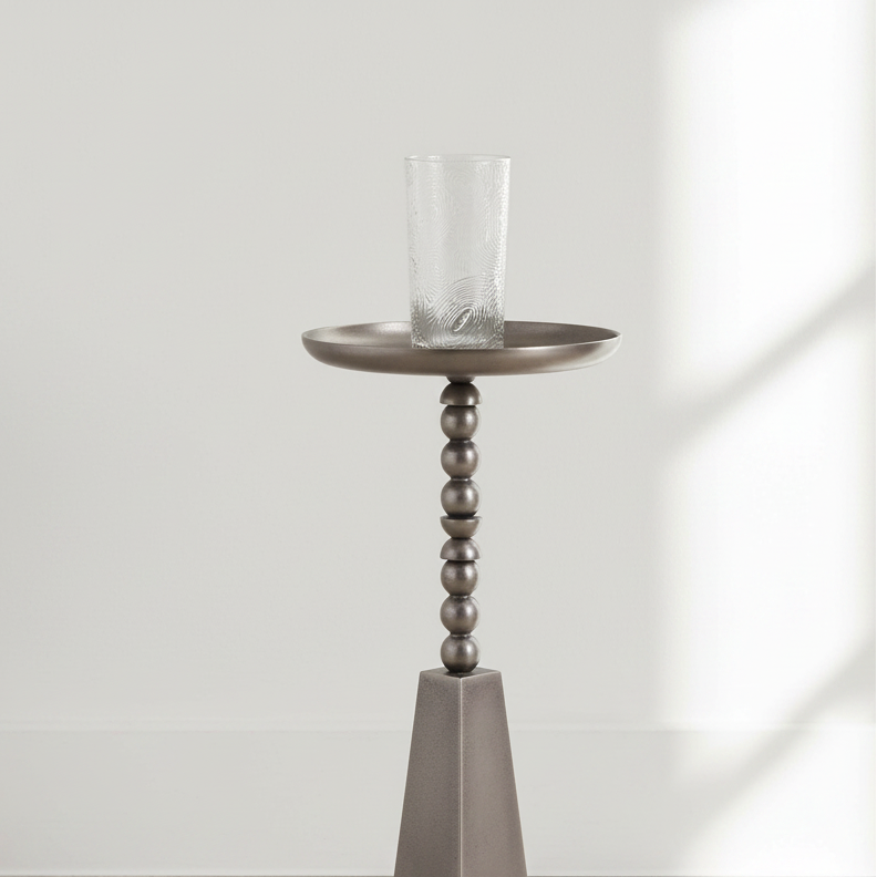 Decorative candle holder with a glass candle on a white floor and light gray wall.