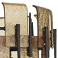 Close-up of a rustic metal wall art piece with textured surfaces and black bars.