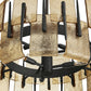 Close-up of a metal grill with black and gold components on a white background