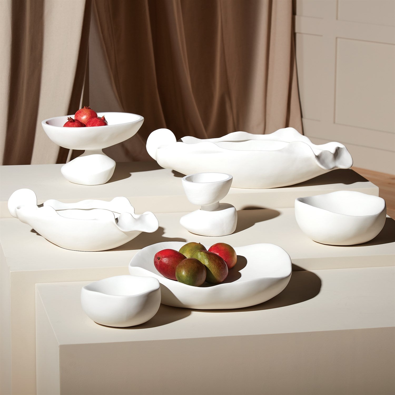 White ceramic bowls on a light surface with a neutral background