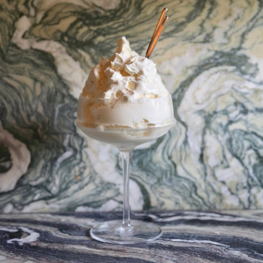 Ice cream dessert in a glass with a marble background