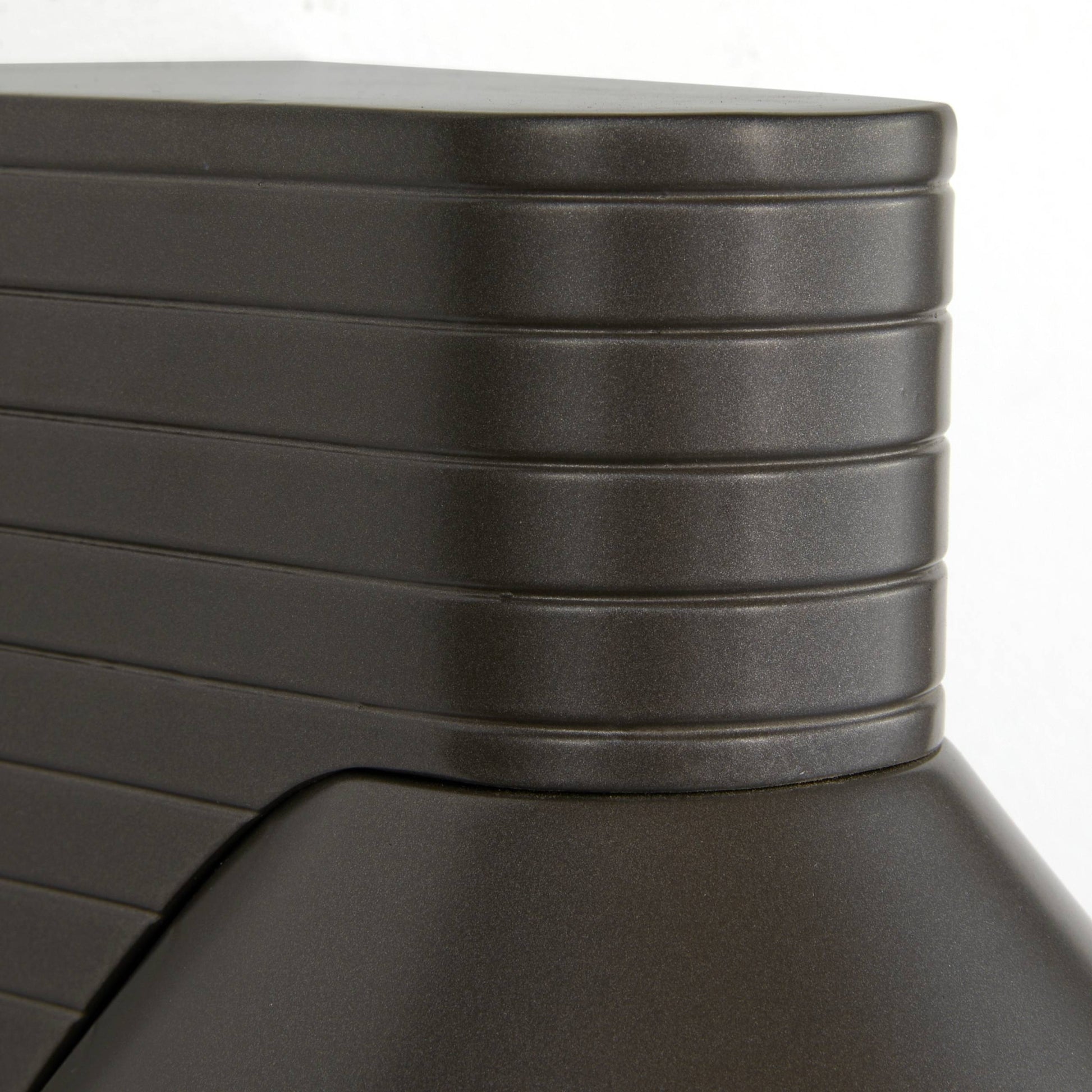 Close-up of a stack of black plastic trays on a white background