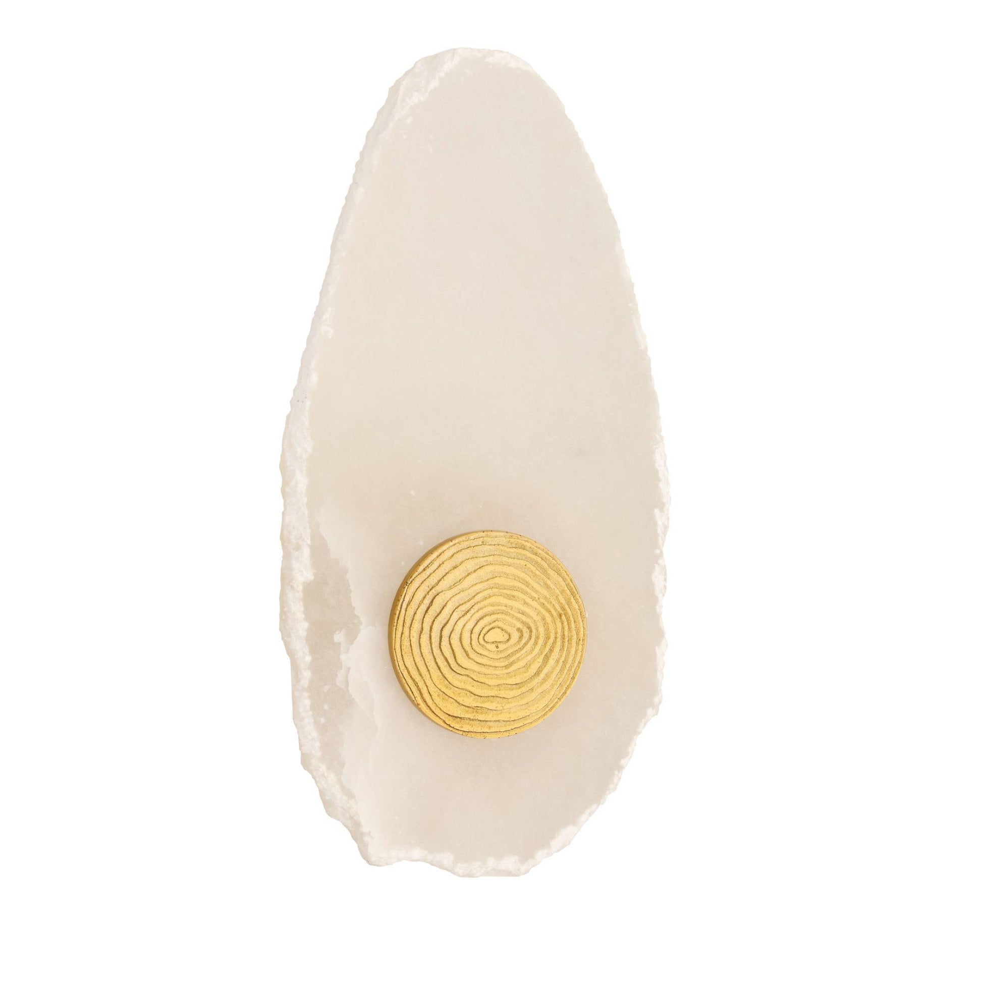 A single gold circular stud earring with concentric ring detailing, displayed on a white textured slate chip against a solid white background.