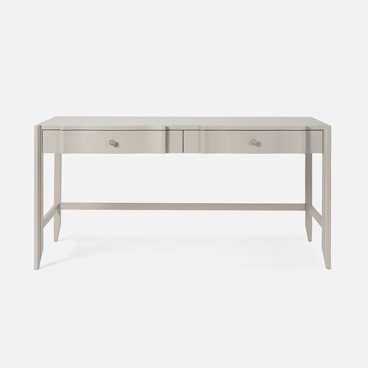 Light gray console table with drawers on a white background