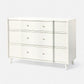 White dresser with four drawers on a white background
