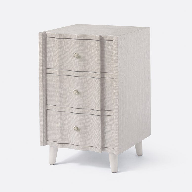 Beige nightstand with three drawers on a white background