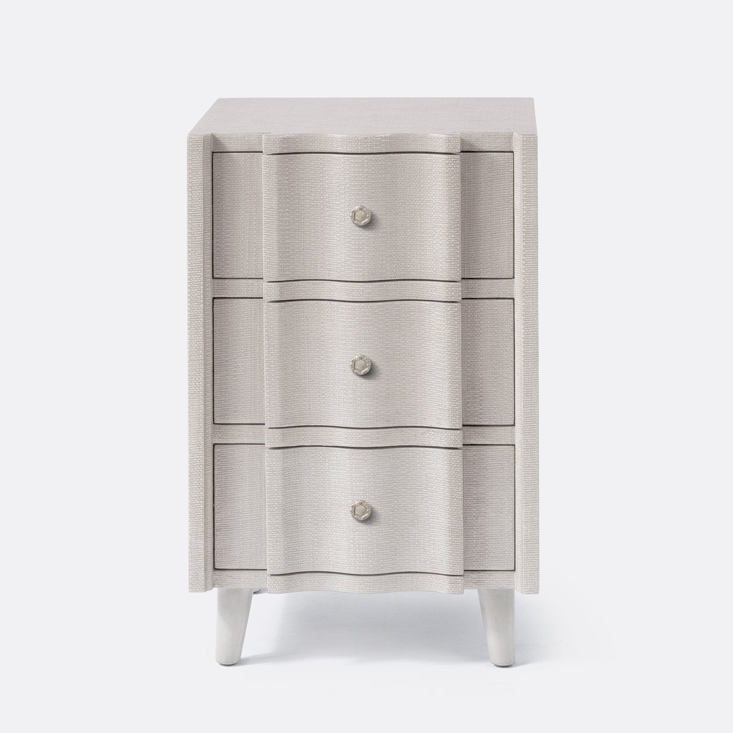 Three-drawer cabinet with textured finish and white legs on a white background