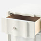 Close-up of a wooden drawer with a white frame on a light gray background