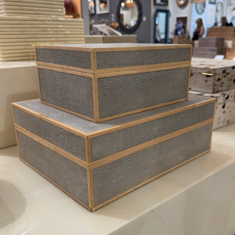 Stack of decorative boxes on a counter in a store setting