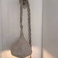 Textured wall light fixture with rope detail on a white wall