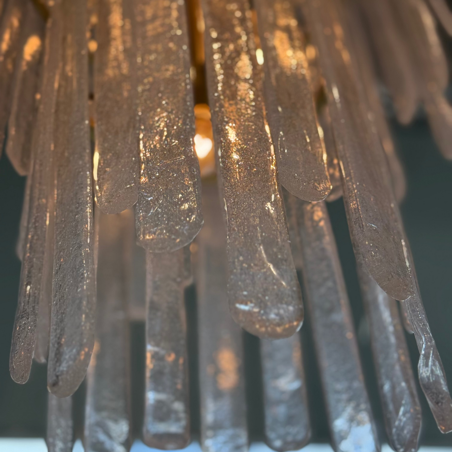 Close-up of a chandelier with glass drops against a blurred background