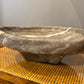 Marble bowl on a wooden surface with a neutral background
