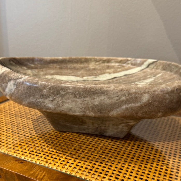 Marble bowl on a wooden surface with a neutral background
