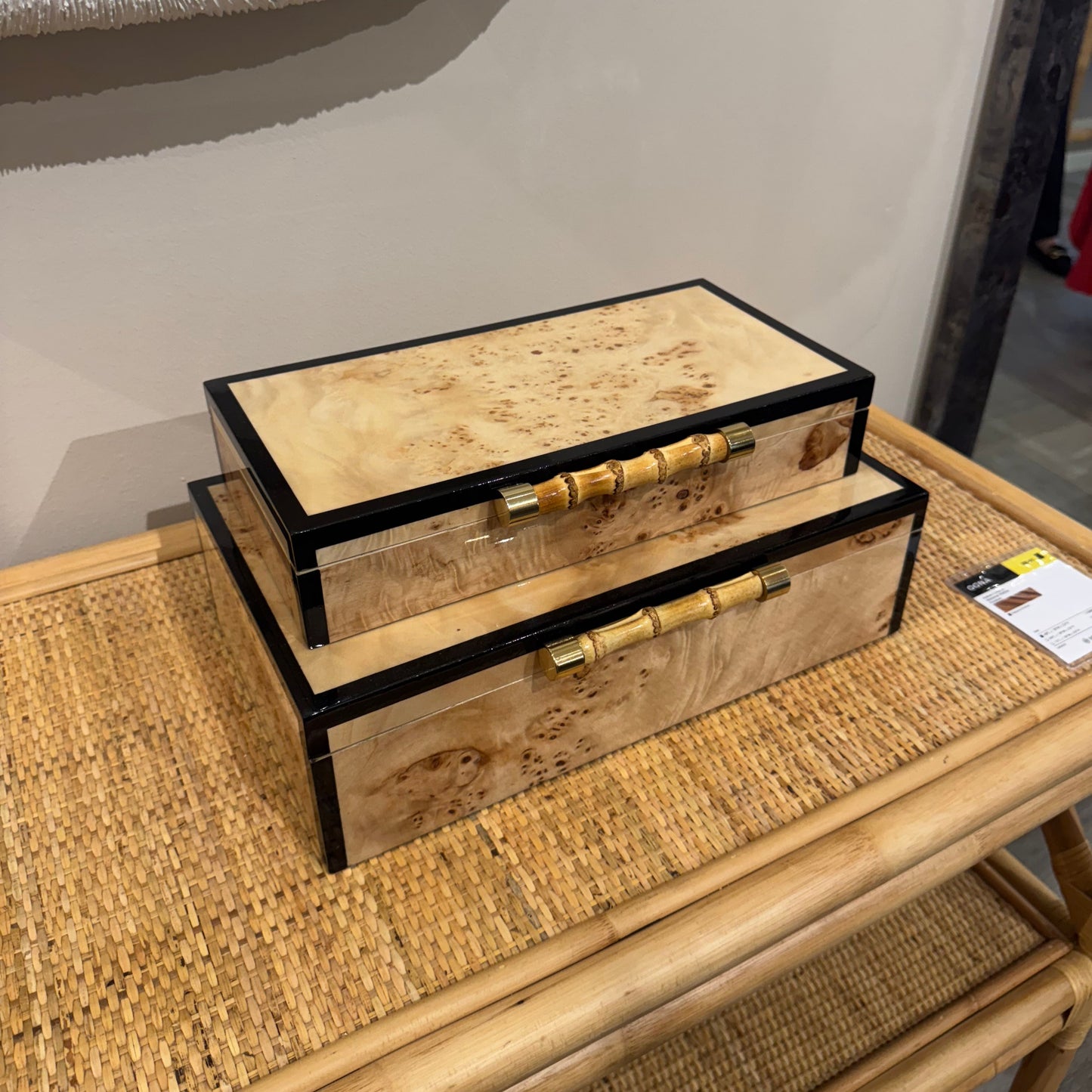 Wooden drawer with wicker frame on a light-colored surface