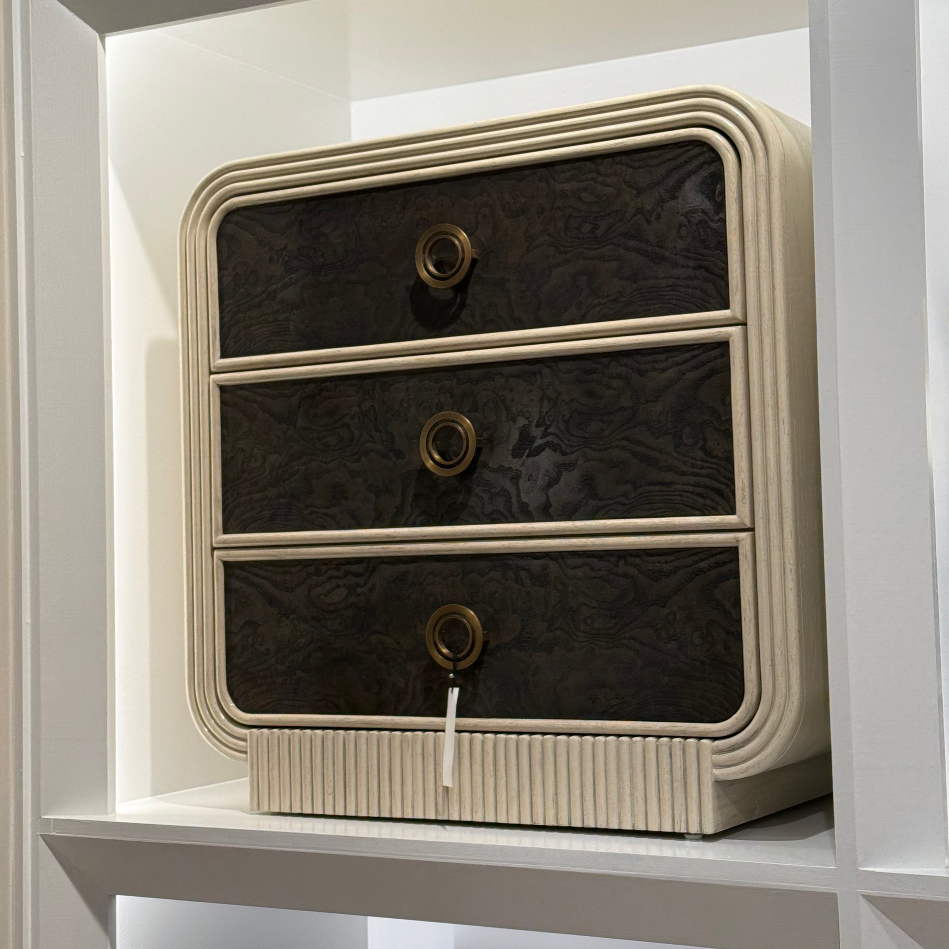 Vintage-style radio with three drawers on a white shelf