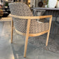 Wicker chair with wooden frame on a concrete floor