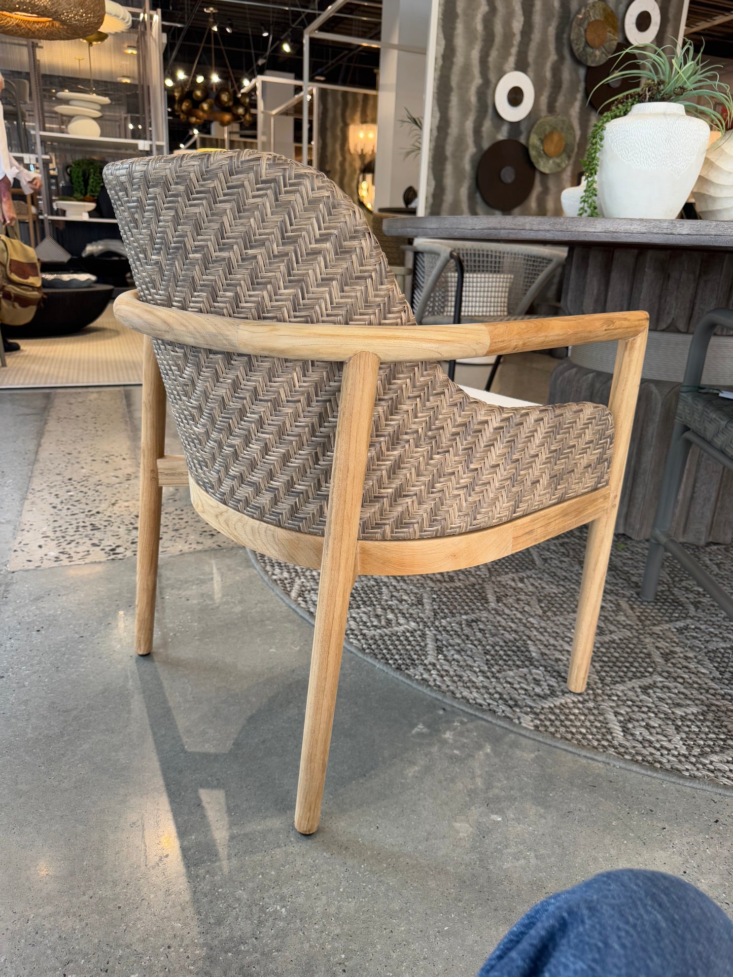 Wicker chair with wooden frame on a concrete floor