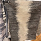 Textured area rug with gradient pattern on a wooden floor