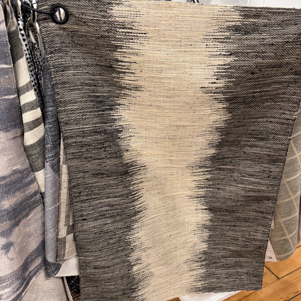 Textured area rug with gradient pattern on a wooden floor