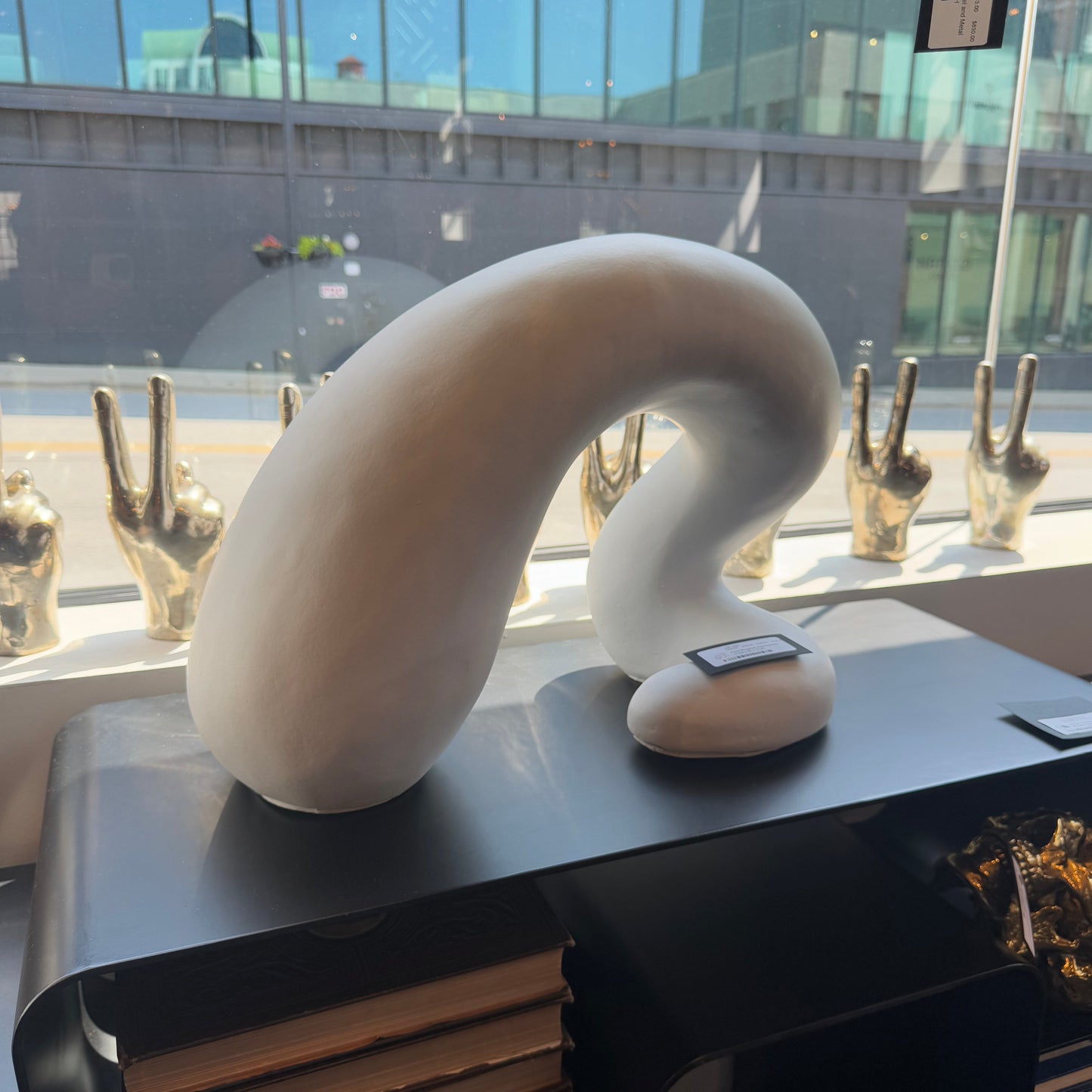 White curved object on a table with a cityscape in the background