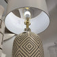 Decorative lamp with geometric patterned base and white shade