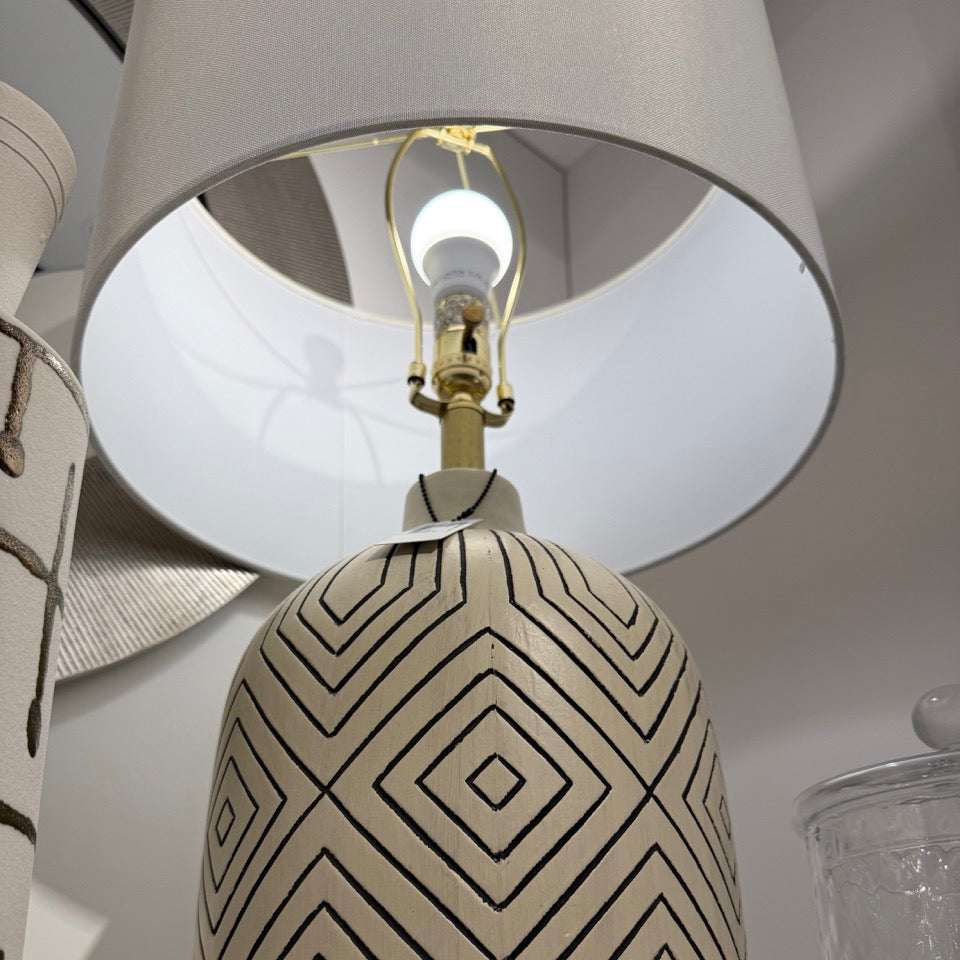Decorative lamp with geometric patterned base and white shade