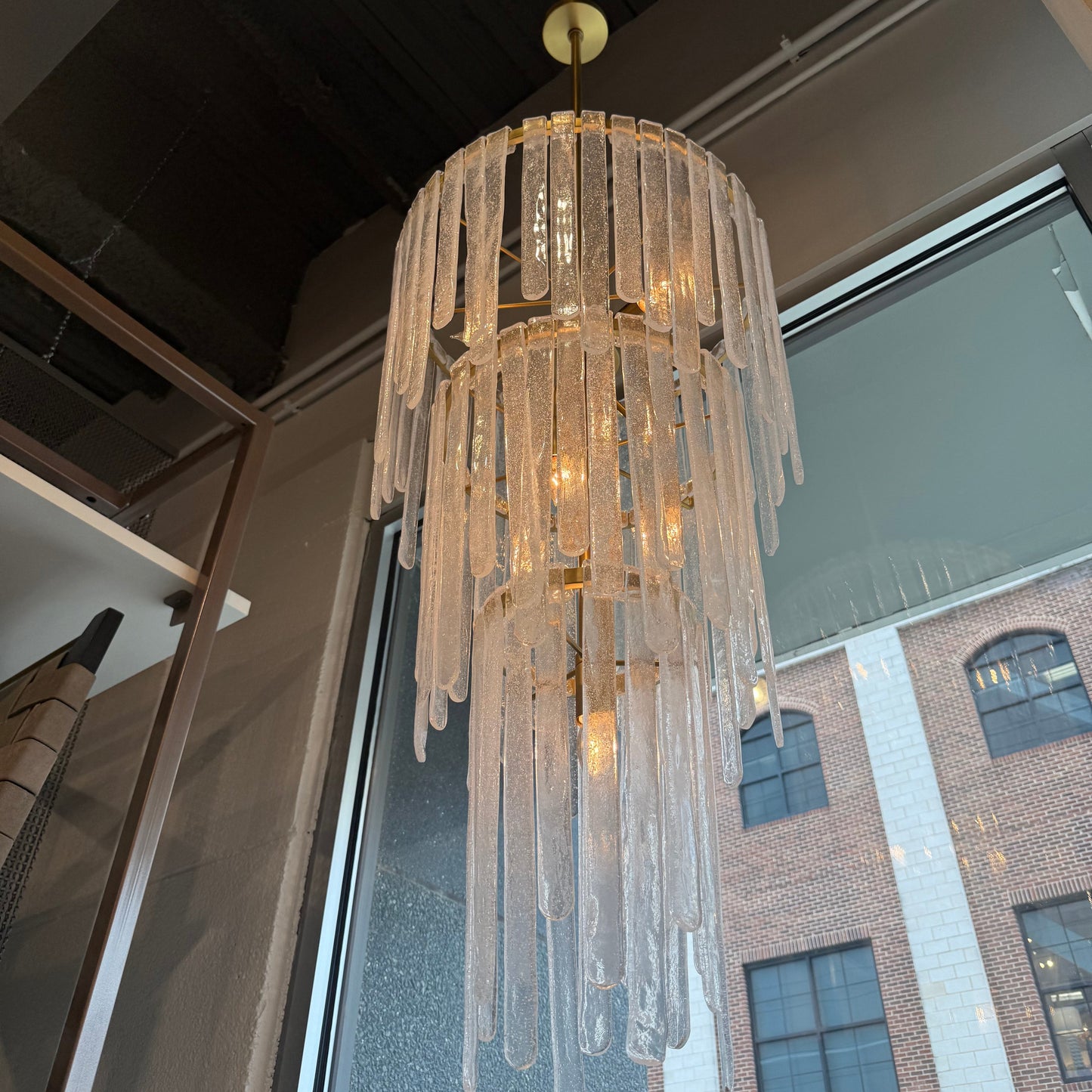 Crystal chandelier in front of a window with a building reflection