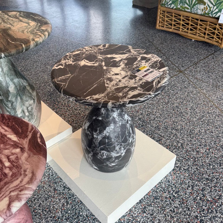 Marble-patterned stools on display in a showroom setting.