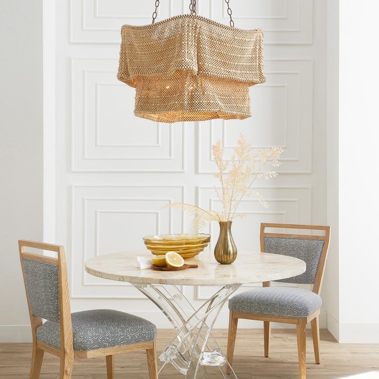 Dining room with a round table, chairs, and decorative elements.