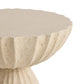 Close-up of a beige stone pedestal with scalloped edge on a white background