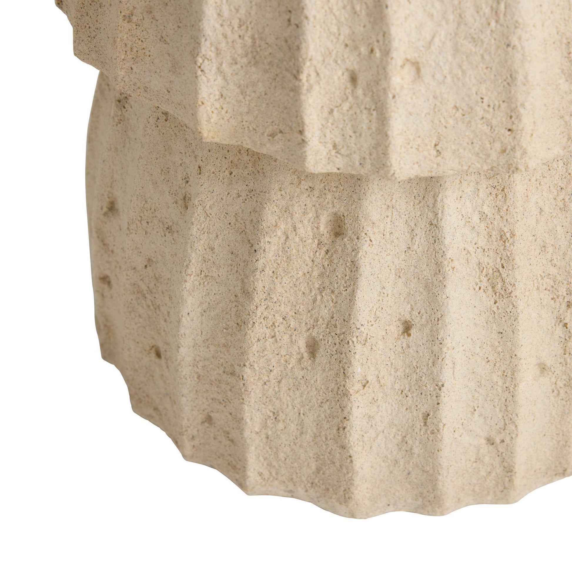 Close-up of a textured stone surface with visible cracks and variations in color.