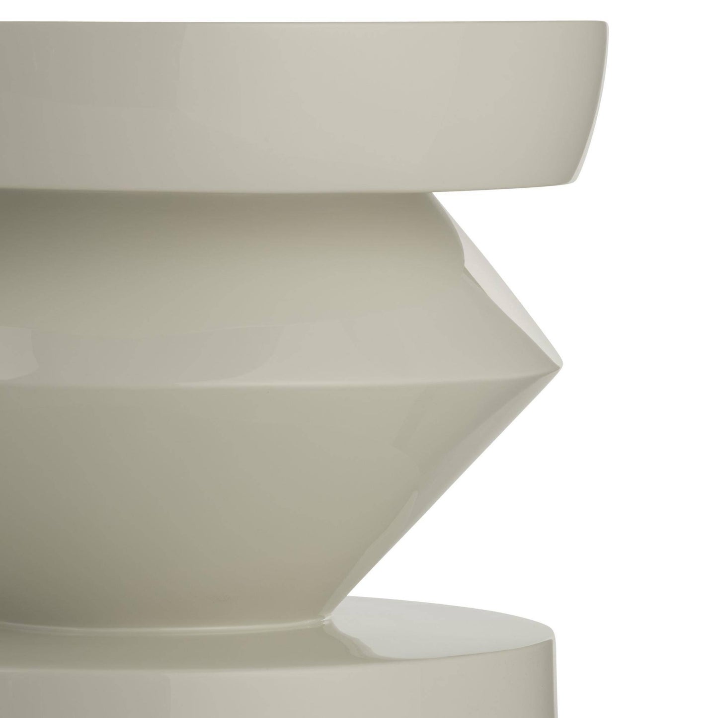 Close-up of a geometrically shaped white ceramic vase on a white background