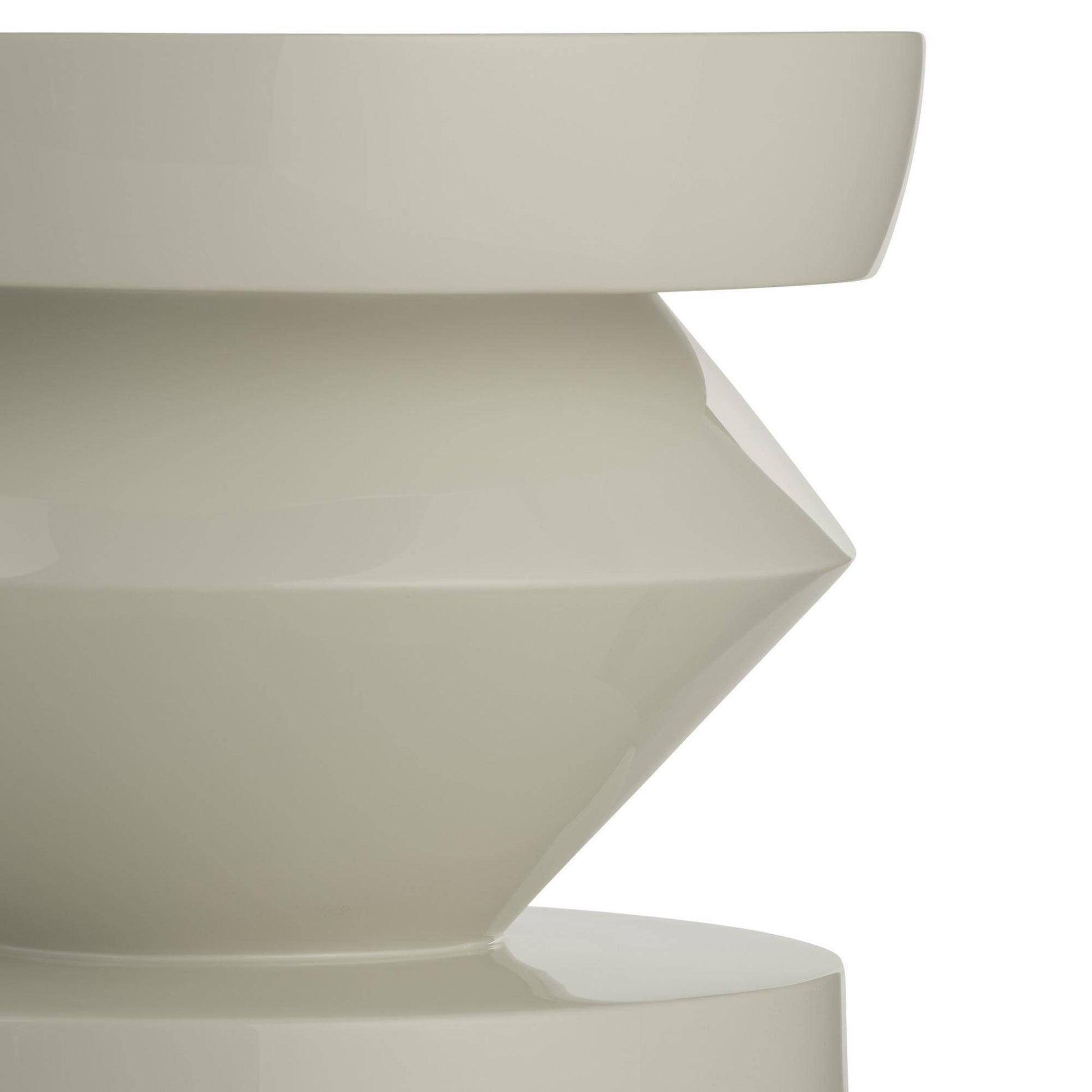 Close-up of a geometrically shaped white ceramic vase on a white background