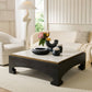 Living room with a coffee table, sofa, and decorative items.