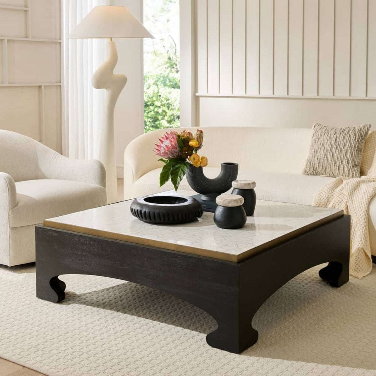 Living room with a coffee table, sofa, and decorative items.