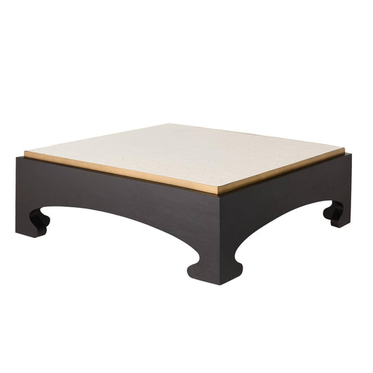 Square coffee table with black base and beige top on a white background