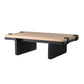A modern low coffee table with a light natural travertine top and a black metal frame and legs, shown on a plain white background.