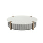 Round outdoor coffee table with a white top, weathered wood posts, and a black geometric chevron lattice base.