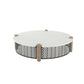 Round outdoor coffee table with a white top, weathered wood posts, and a black geometric chevron lattice base.