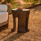 Concrete side table with a plate of food on a gravel surface